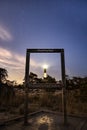 Starry night sky with a lighthouse beacon shining. Fire Island NY Royalty Free Stock Photo