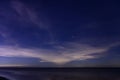 Starry night sky over calm sea beach Royalty Free Stock Photo