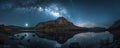 Starry night sky over a tranquil mountain lake Royalty Free Stock Photo