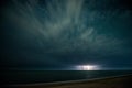 Starry night with thunderstorm and lightning over the sea Royalty Free Stock Photo