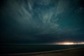 Starry night with thunderstorm and lightning over the sea Royalty Free Stock Photo