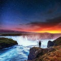 Starry sky above a very beautiful Icelandic waterfall Hodafoss.