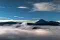 starry sky in the landscape with volcanoes in the clouds, Volcano Bromo National Park