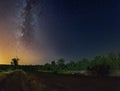 Starry sky with Milky Way galaxy over the summer night rural landscape Royalty Free Stock Photo