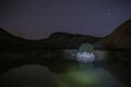 Starry sky reflected in a small lake in the mountains Royalty Free Stock Photo