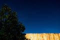 Starry sky with yellow fence and bush