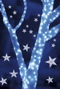 Stars on background of defocused blue lights and tree Royalty Free Stock Photo