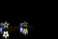 Glowing stars on water with reflection, black Royalty Free Stock Photo