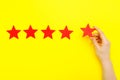 5 stars increase rating, customer experience concept. Hand of client show putting 5 star symbol to increase Service rating. five Royalty Free Stock Photo