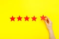 5 stars increase rating, customer experience concept. Hand of client show putting 5 star symbol to increase Service rating. five Royalty Free Stock Photo