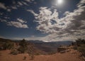 Moon beams light the rim of Smith`s Mesa as lightning strikes east of Zion National park.