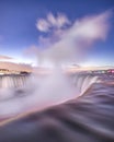 Stars in the night sky over Niagara Falls with mist and spray coming up from Horseshoe Falls Royalty Free Stock Photo