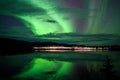 Stars and Northern Lights over dark Road at Lake Royalty Free Stock Photo