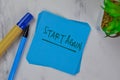 Start Again write on sticky notes isolated on Wooden Table