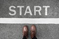 Start background, top view. Selfie of feet and legs in leather ankle boots on pathway. Hipster woman in brown shoes on starting