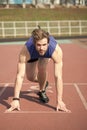 Athletic bearded man with muscular body stretching on running track Royalty Free Stock Photo