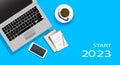 Start 2023 concept with notepad computer, coffee cup , mobile phone and paper work on blue background. vector