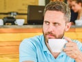 Start day with big cup of coffee. Man bearded serious face needs energy charge. Traditional coffee break cafe background Royalty Free Stock Photo