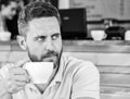 Start day with big cup of coffee. Man bearded serious face needs energy charge. Traditional coffee break cafe background Royalty Free Stock Photo