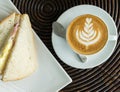 Start The Day with Good Breakfast Concept. Top View of Cup of Cappuccino Coffee with Tree Design Foam on Wooden Panel Table Served Royalty Free Stock Photo