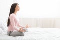 Calm woman practicing yoga at home, side view