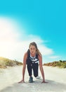 Start with determination and you will end with determination. a sporty young woman getting ready to run outdoors. Royalty Free Stock Photo