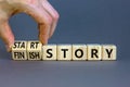 Start or finish story symbol. Concept words Start story and Finish story on wooden cubes. Beautiful grey table grey background. Royalty Free Stock Photo