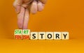 Start or finish story symbol. Concept words Start story and Finish story on wooden cubes. Beautiful orange table orange background Royalty Free Stock Photo