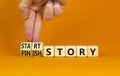 Start or finish story symbol. Concept words Start story and Finish story on wooden cubes. Beautiful orange table orange background Royalty Free Stock Photo