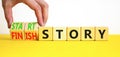 Start or finish story symbol. Concept words Start story and Finish story on wooden cubes. Beautiful yellow table white background Royalty Free Stock Photo