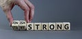 Start and finish strong symbol. Businessman turns wooden cubes, changes words `start strong` to `finish strong`. Beautiful gre