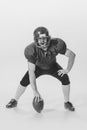 Black and white portrait of american football player in vintage style sports uniform isolated on white background Royalty Free Stock Photo