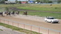 Start of horserace with jockeys in carts