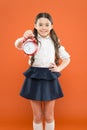 Start lesson. time to go to school. School time. Happy girl hold alarm clock counting for lunch time. Children education Royalty Free Stock Photo