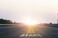 Start line wording with yellow arrow to glowing sunlight on super high way for business and challenge plan of career path concept Royalty Free Stock Photo