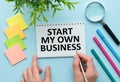 Start My Own Business text written in Notebook, Business concept, blue background, Pencil, Notebook and calculator Royalty Free Stock Photo