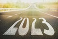 Start new year with fresh vision and ideas. 2023 numbers on asphalt road Royalty Free Stock Photo