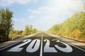 Start new year with fresh vision and ideas. 2023 numbers on asphalt road Royalty Free Stock Photo