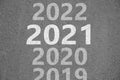 Start new year with fresh vision and ideas. 2021 numbers bigger than others on asphalt road