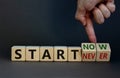 Start now or never symbol. Businessman turns wooden cubes and changes words `start never` to `start now`. Beautiful grey