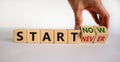 Start now or never symbol. Businessman turns wooden cubes and changes words `start never` to `start now`. Beautiful white