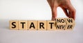 Start now or never symbol. Businessman turns wooden cubes and changes words `start never` to `start now`. Beautiful white