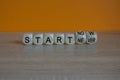 Start now or never symbol. Turned wooden cubes and changes words start never to start now