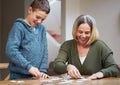 Start from the outside work your way in. a mother completing a puzzle with her son.