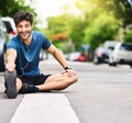 Start the race to a better lifestyle. Portrait of a sporty young man stretching his legs while exercising outdoors.