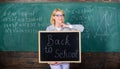 Start school year. Top ways to welcome students back to school. Teacher woman hold blackboard inscription back to school