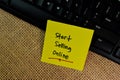 Start Selling Online write on sticky notes isolated on Wooden Table