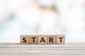 Start sign on a wooden table Royalty Free Stock Photo