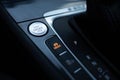 Start-stop buttons on modern cars selective focus. Silver start and stop button. Automatic electric car Royalty Free Stock Photo