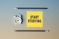 Start Studying - text on sticky note paper. Closeup of a personal agenda. Top view Royalty Free Stock Photo